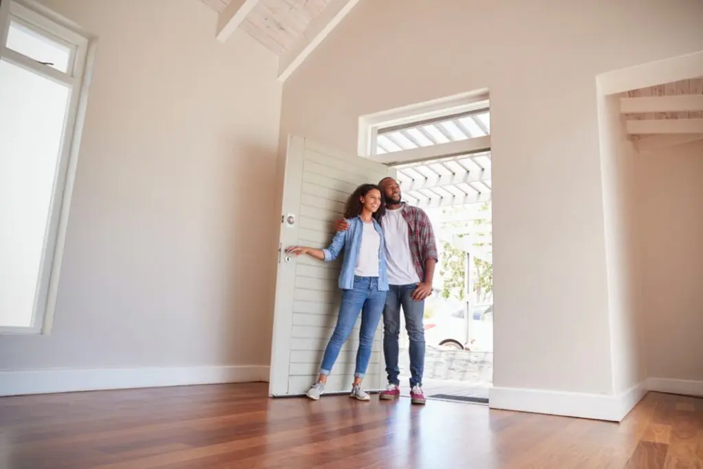 Couple walking into empty house