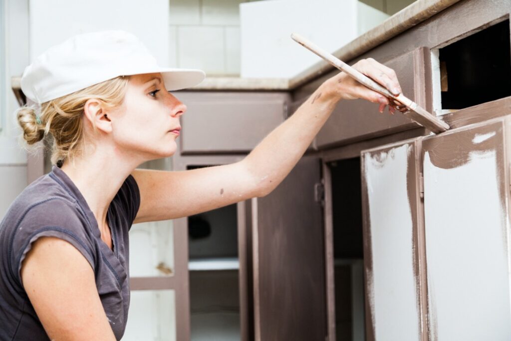 Woman painting cabinets