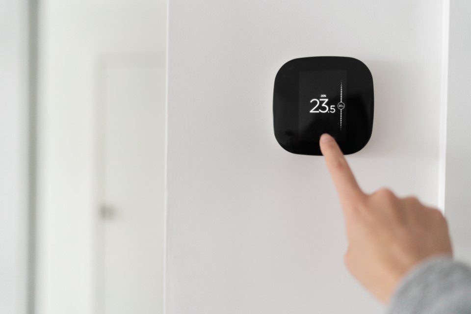 Smart thermostat installed inside home